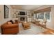 Living room featuring a fireplace, built-in shelving and hardwood floors at 6941 S Poplar Way, Centennial, CO 80112