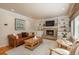 Living room with a fireplace, built-in shelves, and hardwood floors at 6941 S Poplar Way, Centennial, CO 80112