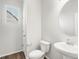 Clean powder room featuring a pedestal sink and wood-look flooring at 8807 Sedalia St, Commerce City, CO 80022