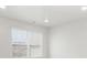 Bright bedroom featuring a large window with blinds and ample natural light at 8807 Sedalia St, Commerce City, CO 80022
