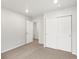This bedroom features neutral paint, plush carpet, and a closet at 8807 Sedalia St, Commerce City, CO 80022