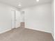 This bedroom features neutral paint, plush carpet, and white doors at 8807 Sedalia St, Commerce City, CO 80022
