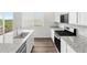 Open kitchen features granite counters, an island with sink, and modern appliances at 8807 Sedalia St, Commerce City, CO 80022