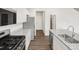 Modern kitchen showcasing granite counters, stainless appliances, and stylish flooring at 8807 Sedalia St, Commerce City, CO 80022