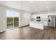 Open kitchen featuring an island, stainless appliances, and a sliding door to the deck at 8807 Sedalia St, Commerce City, CO 80022
