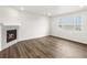Living room featuring a fireplace and vinyl plank floors at 8807 Sedalia St, Commerce City, CO 80022
