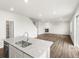 Open concept living area with a fireplace and access to a modern kitchen at 8807 Sedalia St, Commerce City, CO 80022