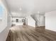 Open-concept living area with hardwood floors and white cabinets at 8807 Sedalia St, Commerce City, CO 80022