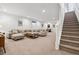 A spacious finished basement provides ample seating, a stairwell, and entertainment space at 11466 E 27Th Ave, Denver, CO 80238