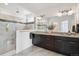 A spacious bathroom features a large mirror, dual sinks, a glass shower, and modern fixtures at 11466 E 27Th Ave, Denver, CO 80238