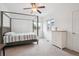 Cozy bedroom featuring natural light, neutral walls, carpet, and a decorative four-poster bed at 11466 E 27Th Ave, Denver, CO 80238