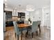 Open concept dining room with hardwood floors adjacent to kitchen at 11466 E 27Th Ave, Denver, CO 80238