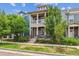 Charming two-story home boasts a cozy front porch, complemented by verdant landscaping and beautiful curb appeal at 11466 E 27Th Ave, Denver, CO 80238
