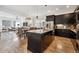Spacious kitchen with dark cabinetry, granite countertops, stainless steel appliances, and an open concept layout at 11466 E 27Th Ave, Denver, CO 80238