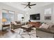 Comfortable living room with modern decor, hardwood floors, and large windows at 11466 E 27Th Ave, Denver, CO 80238