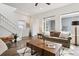 Bright living room with hardwood floors, large windows, and comfortable seating arrangement at 11466 E 27Th Ave, Denver, CO 80238