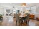 Open concept living room and dining area with hardwood floors and natural light at 11466 E 27Th Ave, Denver, CO 80238