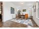 Bright home office featuring hardwood floors, natural light, modern furnishings, and a stylish geometric area rug at 11466 E 27Th Ave, Denver, CO 80238