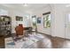 Bright home office featuring hardwood floors, natural light, modern furnishings, and a stylish geometric area rug at 11466 E 27Th Ave, Denver, CO 80238
