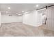Spacious basement with carpeted floors and bright, recessed lighting, and a sliding barn door at 5914 S Kearney St, Centennial, CO 80111