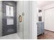 Luxurious shower with unique tile, glass door, and built-in niche, next to a vanity at 5914 S Kearney St, Centennial, CO 80111