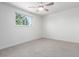 Bright bedroom featuring neutral carpeting, and a window overlooking greenery at 5914 S Kearney St, Centennial, CO 80111