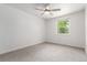 Cozy bedroom featuring plush carpeting, a ceiling fan, and a large window at 5914 S Kearney St, Centennial, CO 80111