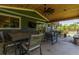 Relaxing covered back patio including outdoor seating, a dining area, and overhead ceiling fan at 5914 S Kearney St, Centennial, CO 80111