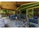Back covered patio with outdoor furniture, ceiling fan, heater and sliding glass doors to the house at 5914 S Kearney St, Centennial, CO 80111