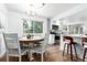 Bright dining area with a round table and stylish chairs, adjacent to the kitchen with bar stool seating at 5914 S Kearney St, Centennial, CO 80111