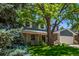Charming two-story home with a manicured lawn and mature tree, offering a welcoming curb appeal at 5914 S Kearney St, Centennial, CO 80111