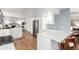 Modern kitchen with white cabinets, stainless steel appliances, and a breakfast bar, perfect for casual dining at 5914 S Kearney St, Centennial, CO 80111