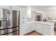 Bright kitchen featuring white cabinets, stainless steel appliances, and quartz countertops at 5914 S Kearney St, Centennial, CO 80111