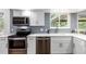 Well-equipped kitchen featuring stainless steel appliances, white cabinetry, and tile backsplash at 5914 S Kearney St, Centennial, CO 80111