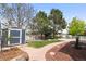 Backyard with concrete sidewalk and a garden shed at 1118 S Duquesne Cir, Aurora, CO 80018