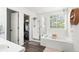 Bright bathroom with a walk-in shower, soaking tub, and a large window at 1118 S Duquesne Cir, Aurora, CO 80018