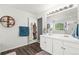 Bathroom with double vanity, modern mirrors and fixtures, and a glass enclosed shower at 1118 S Duquesne Cir, Aurora, CO 80018