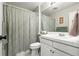 Bathroom with a shower/tub combo, neutral color scheme, and tile flooring at 1118 S Duquesne Cir, Aurora, CO 80018