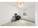 A clean and vacant bedroom with a single window, desk, and neutral carpet at 1118 S Duquesne Cir, Aurora, CO 80018