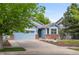 Charming blue home with a two-car garage, manicured lawn, and appealing curb appeal at 1118 S Duquesne Cir, Aurora, CO 80018