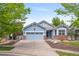 Charming blue home with a two-car garage, brick accents, and well-manicured front yard at 1118 S Duquesne Cir, Aurora, CO 80018