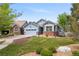Beautiful single-Gathering home featuring an attached garage, lawn, and cozy front porch at 1118 S Duquesne Cir, Aurora, CO 80018