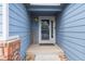 Inviting front porch with brick detail and 'Welcome' sign at 1118 S Duquesne Cir, Aurora, CO 80018