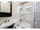 Elegant bathroom featuring marble tile, a shower-tub combo, and modern fixtures, creating a spa-like experience at 284 S Lafayette St, Denver, CO 80209