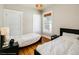 Bright bedroom with two beds, hardwood floors, and natural light, creating a comfortable and inviting space at 284 S Lafayette St, Denver, CO 80209