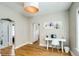 This modern home office features a sleek white desk and chair, illuminated by a stylish pendant light fixture at 284 S Lafayette St, Denver, CO 80209