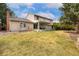 Spacious backyard featuring a well-maintained lawn and a covered patio, perfect for outdoor enjoyment at 8510 Independence Way, Arvada, CO 80005