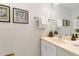 Powder room with a sink, a mirror, and a towel rack, perfect for guests at 8510 Independence Way, Arvada, CO 80005