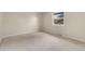 Empty bedroom showcasing neutral carpet, a window, and baseboard trim at 8510 Independence Way, Arvada, CO 80005