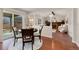 Cozy dining area open to living room with a round table and natural light from sliding glass doors at 8510 Independence Way, Arvada, CO 80005